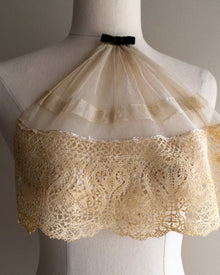 Lace jabot on a mannequin against a neutral background