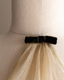 Mannequin wearing a lace jabot with a black bow detail
