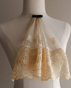 Lace jabot on a mannequin against a neutral background