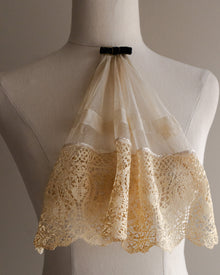 Lace jabot on a mannequin against a neutral background