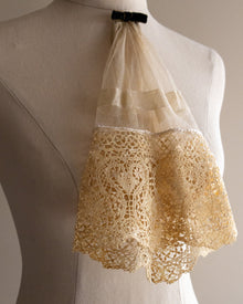 Lace jabot on a mannequin with a neutral background