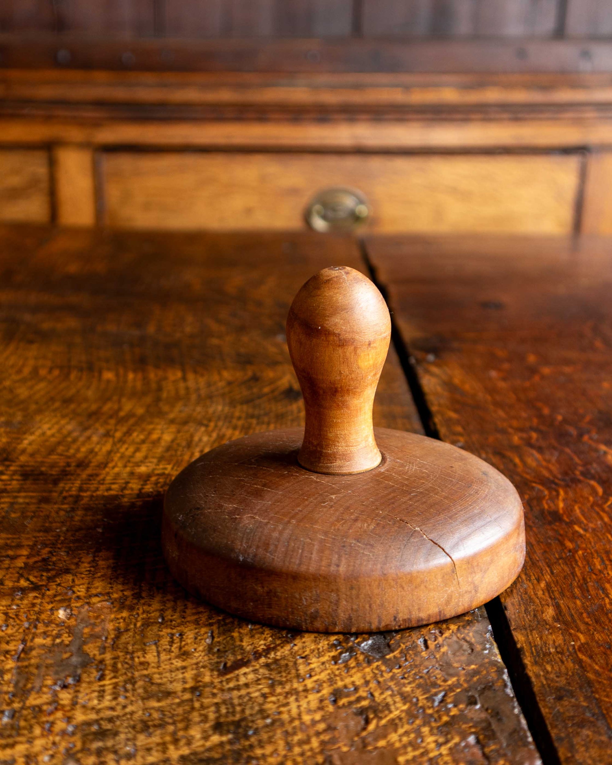 Wooden butter stamp on a rustic wooden surface