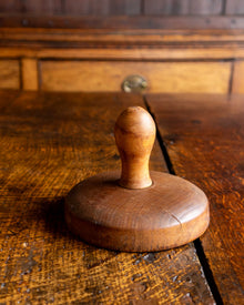 Wooden butter stamp on a rustic wooden surface