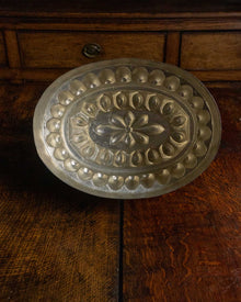 Inside of a copper mould on wooden surface