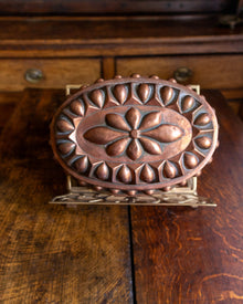 Decorative copper mould on a wooden surface