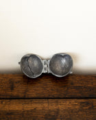 Decorative pewter mould on a white background