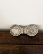 Decorative pewter mould on a white background