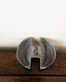 Decorative pewter mould on a white background