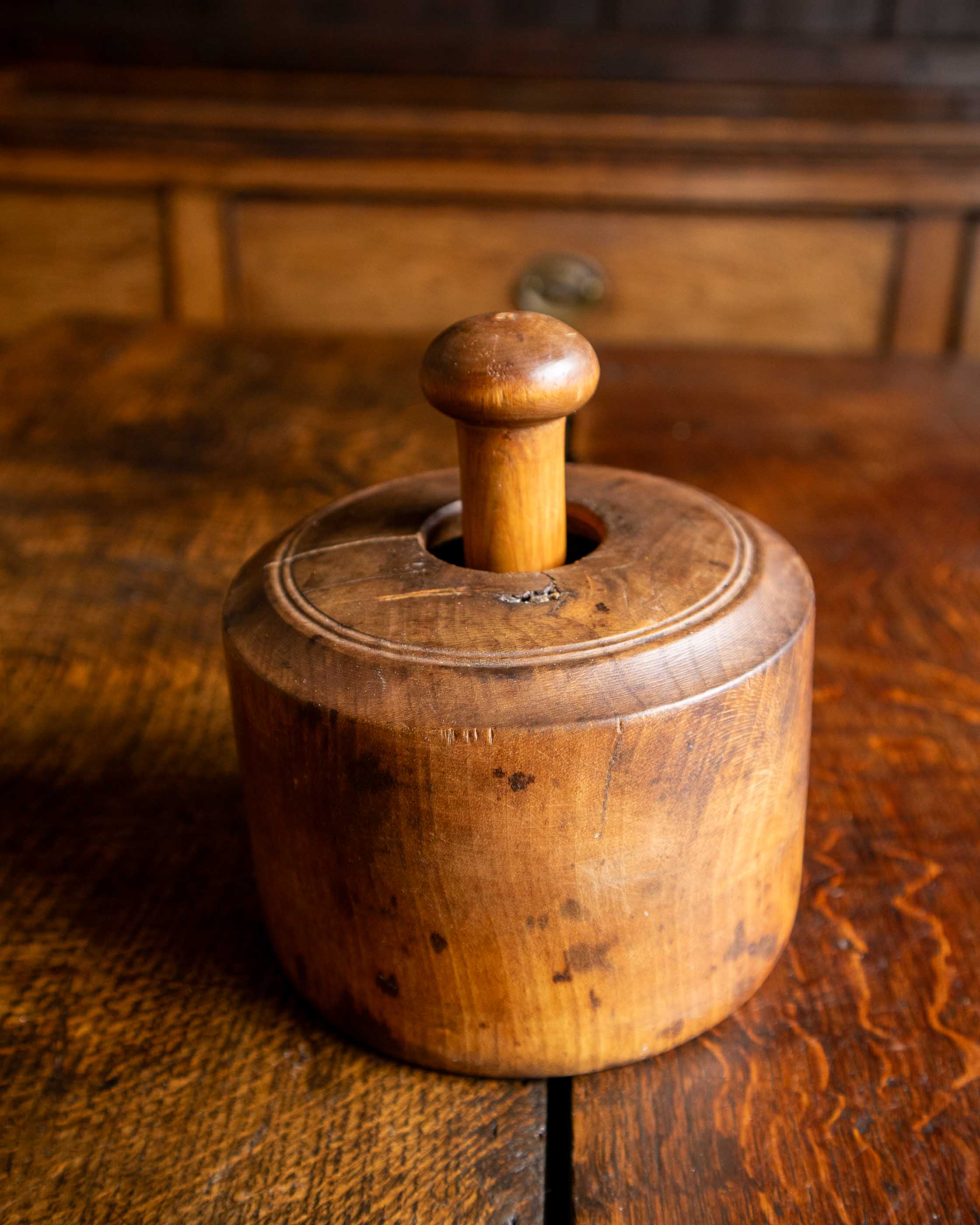 Wooden butter mould on a wooden surface