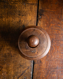 Wooden butter mould from the top on a wooden door