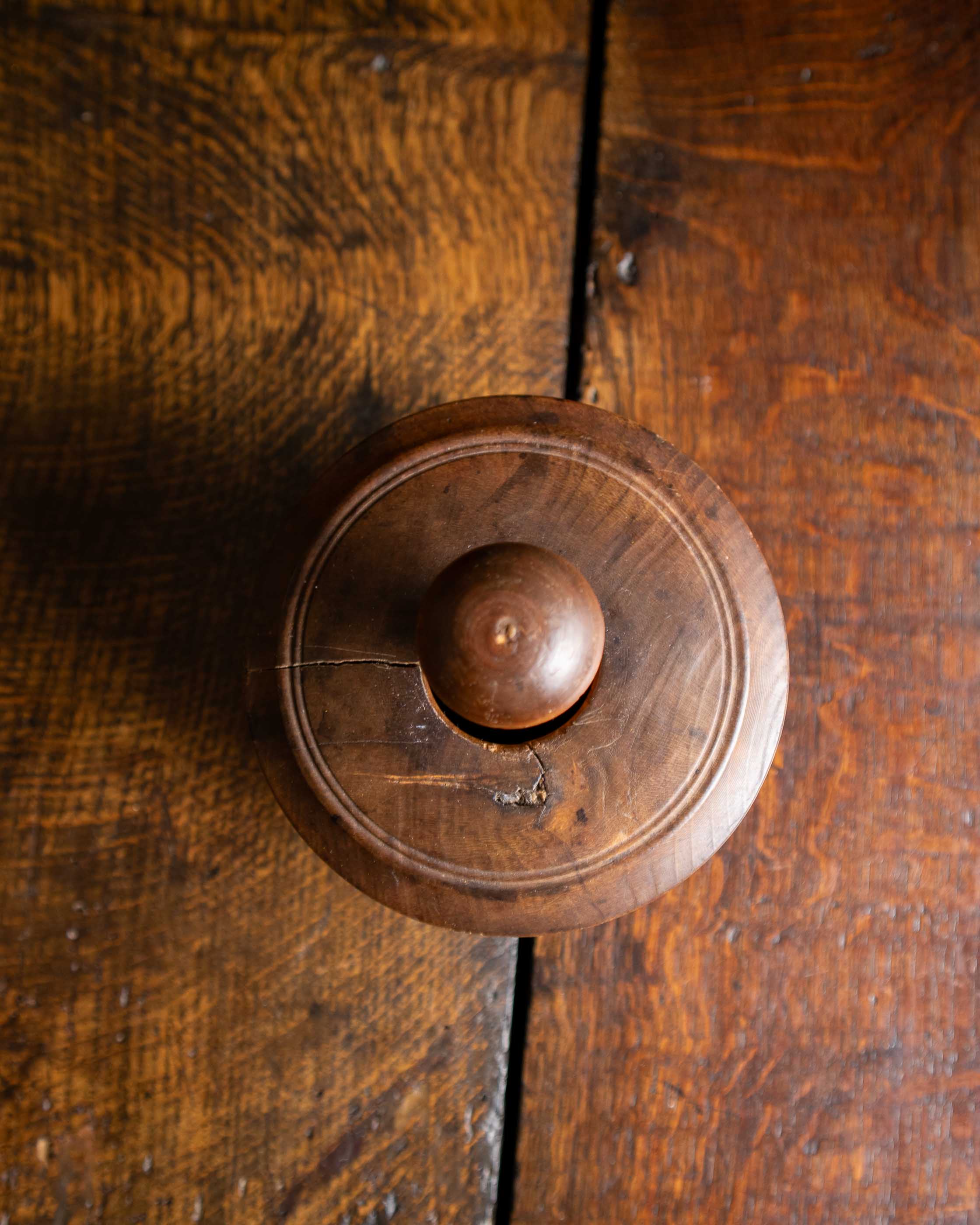 Wooden butter mould from the top on a wooden door