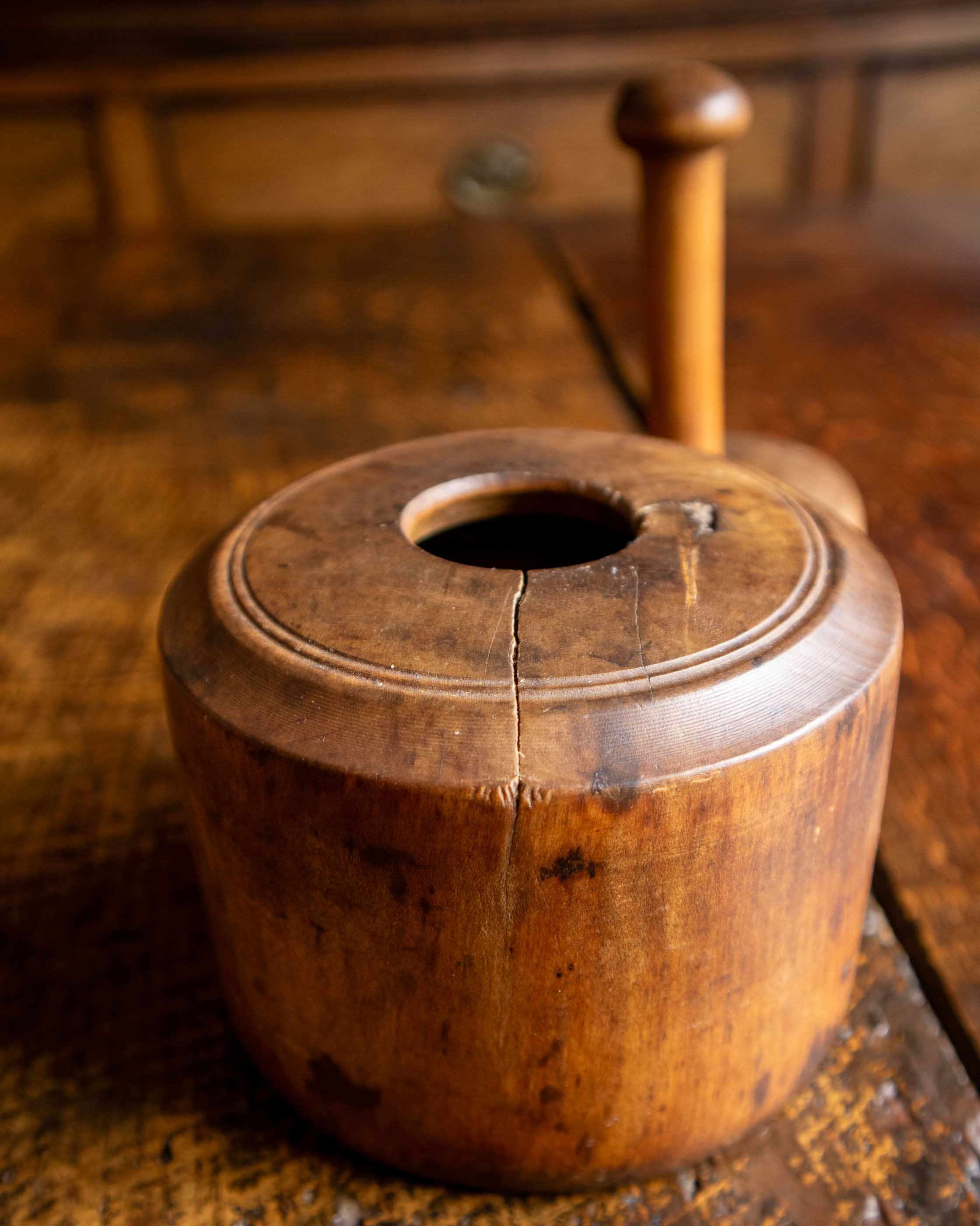 Wooden butter mould on a wooden surface with a blurred background