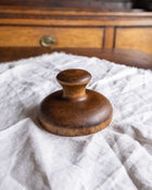 Wooden butter print on a textured white surface with a wooden background