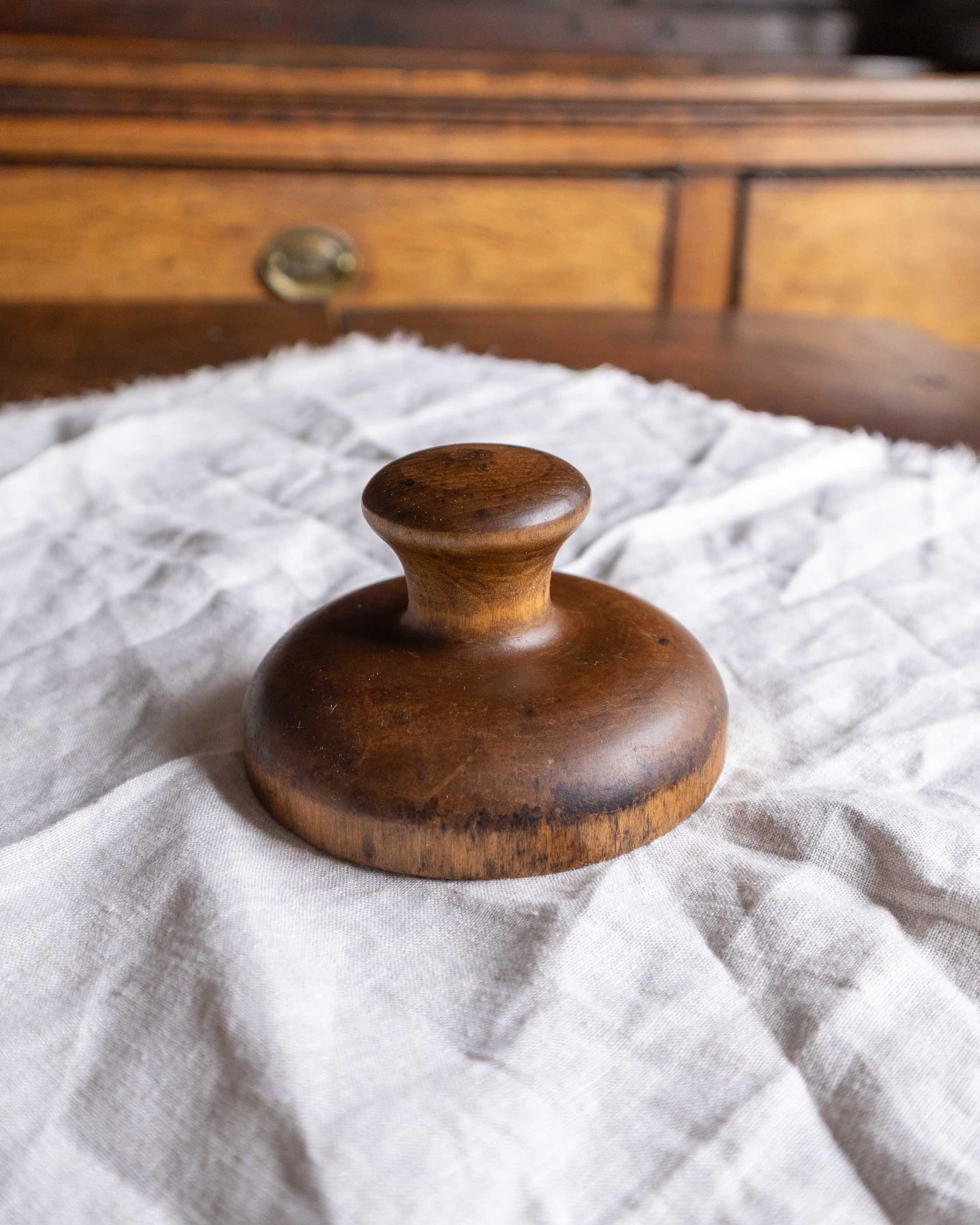 Wooden butter print on a textured white surface with a wooden background