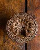 Decorative wooden stamp with intricate design on a wooden surface