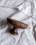 Wooden butter print on a textured white fabric background