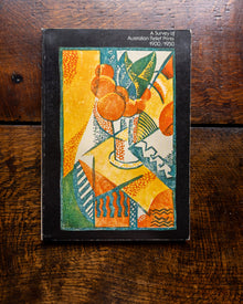 Book cover with abstract design on a wooden surface