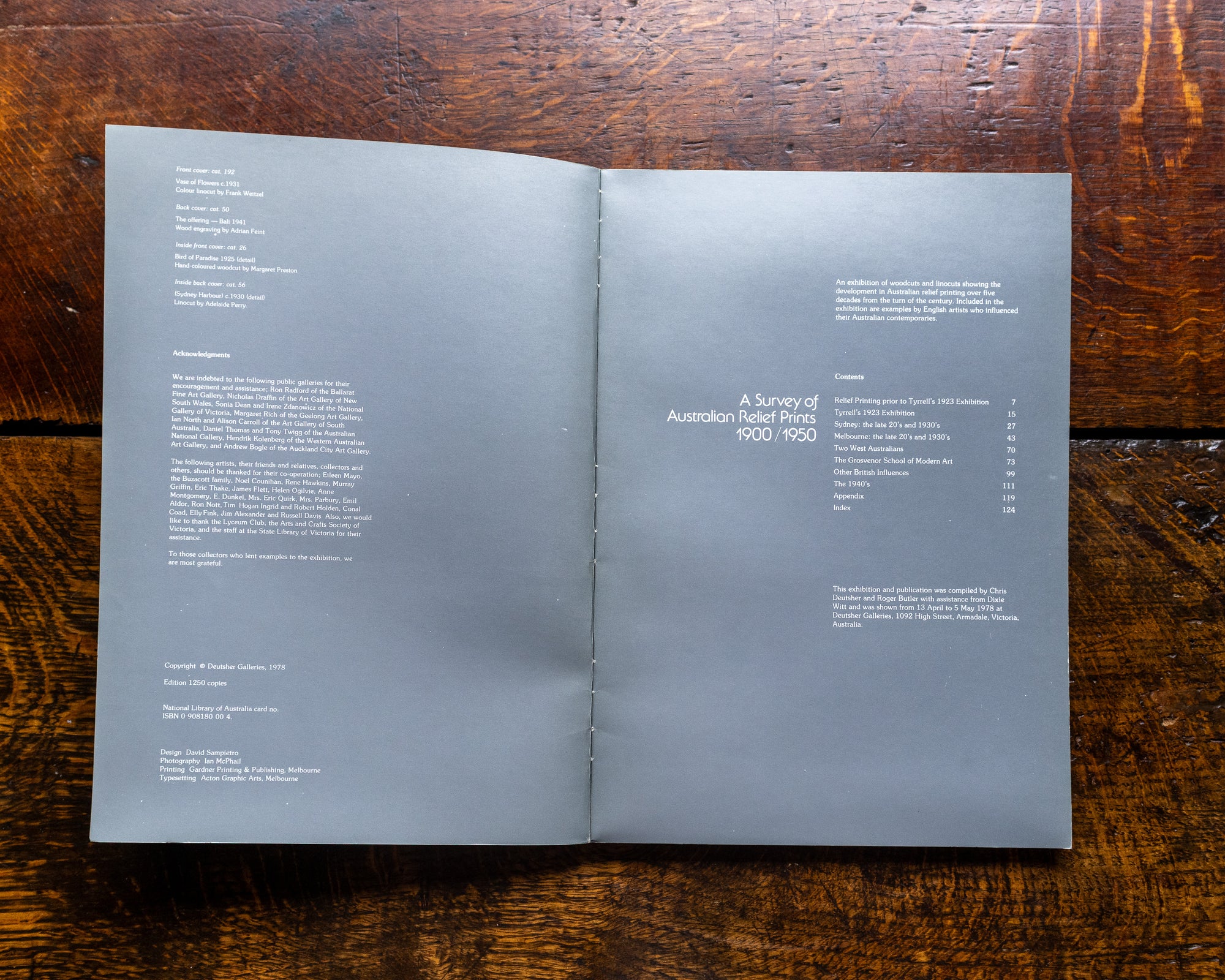 Open book on a wooden surface with text visible