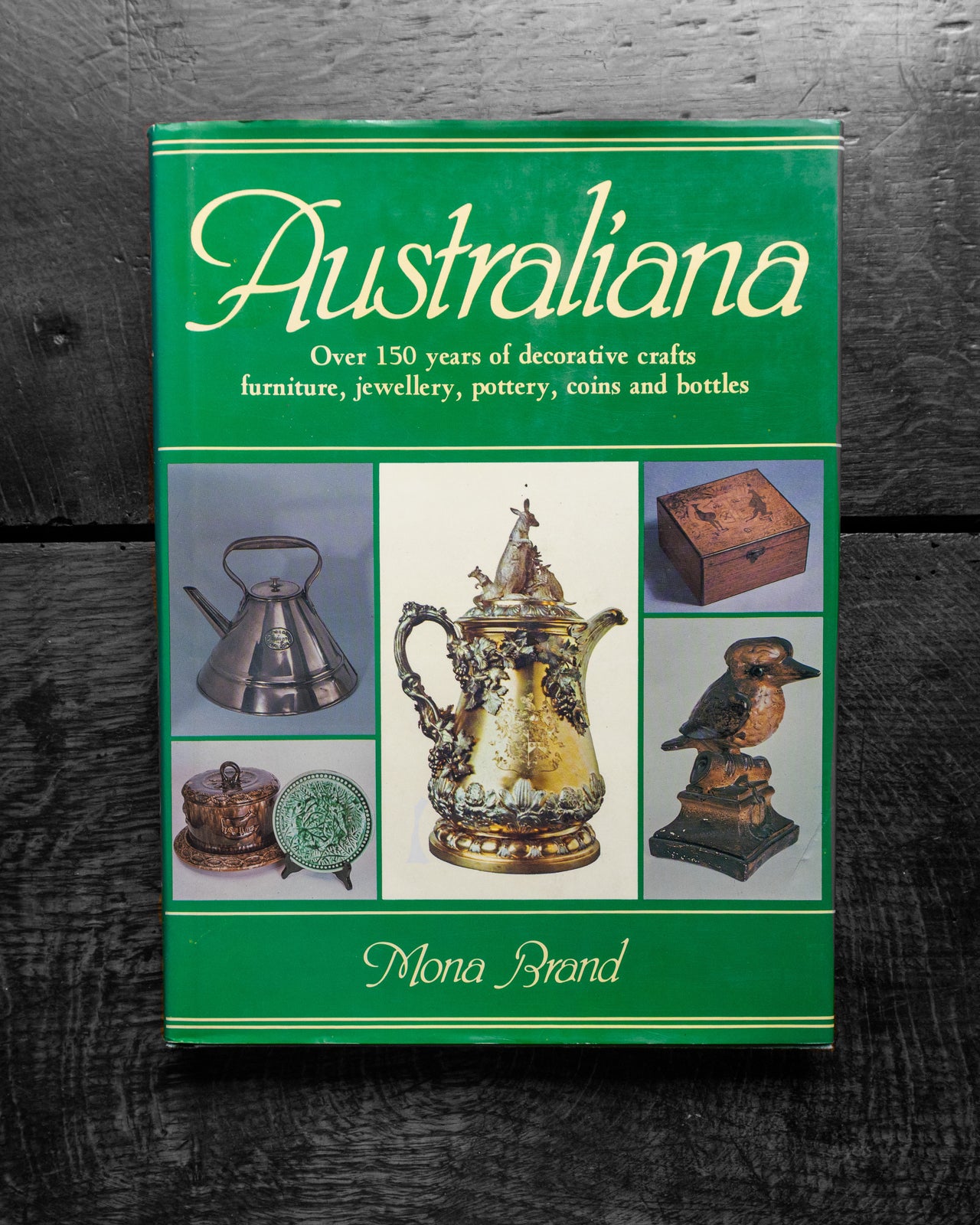 Book titled 'Australiana' with images of decorative crafts on a dark background