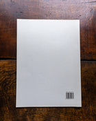 Back cover with a barcode on a wooden surface