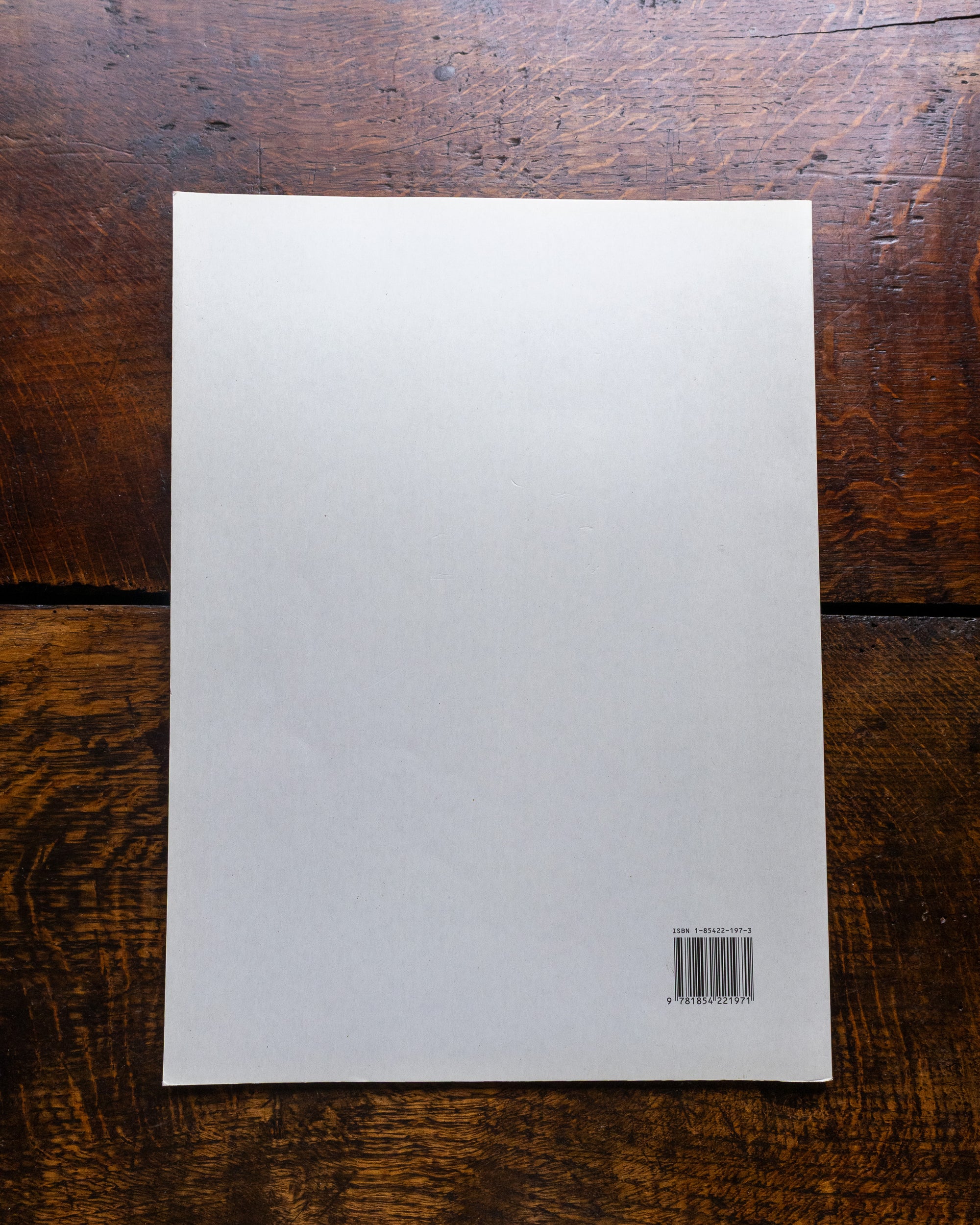 Back cover with a barcode on a wooden surface