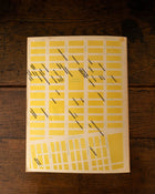 Back cover of 'Eastvillage' with illustration on a wooden background