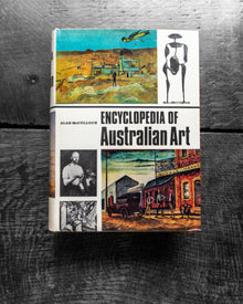 Book titled 'Encyclopedia of Australian Art' on a textured surface