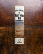 Book titled 'Encyclopedia of Australian Art' by Alan McCulloch on a wooden surface
