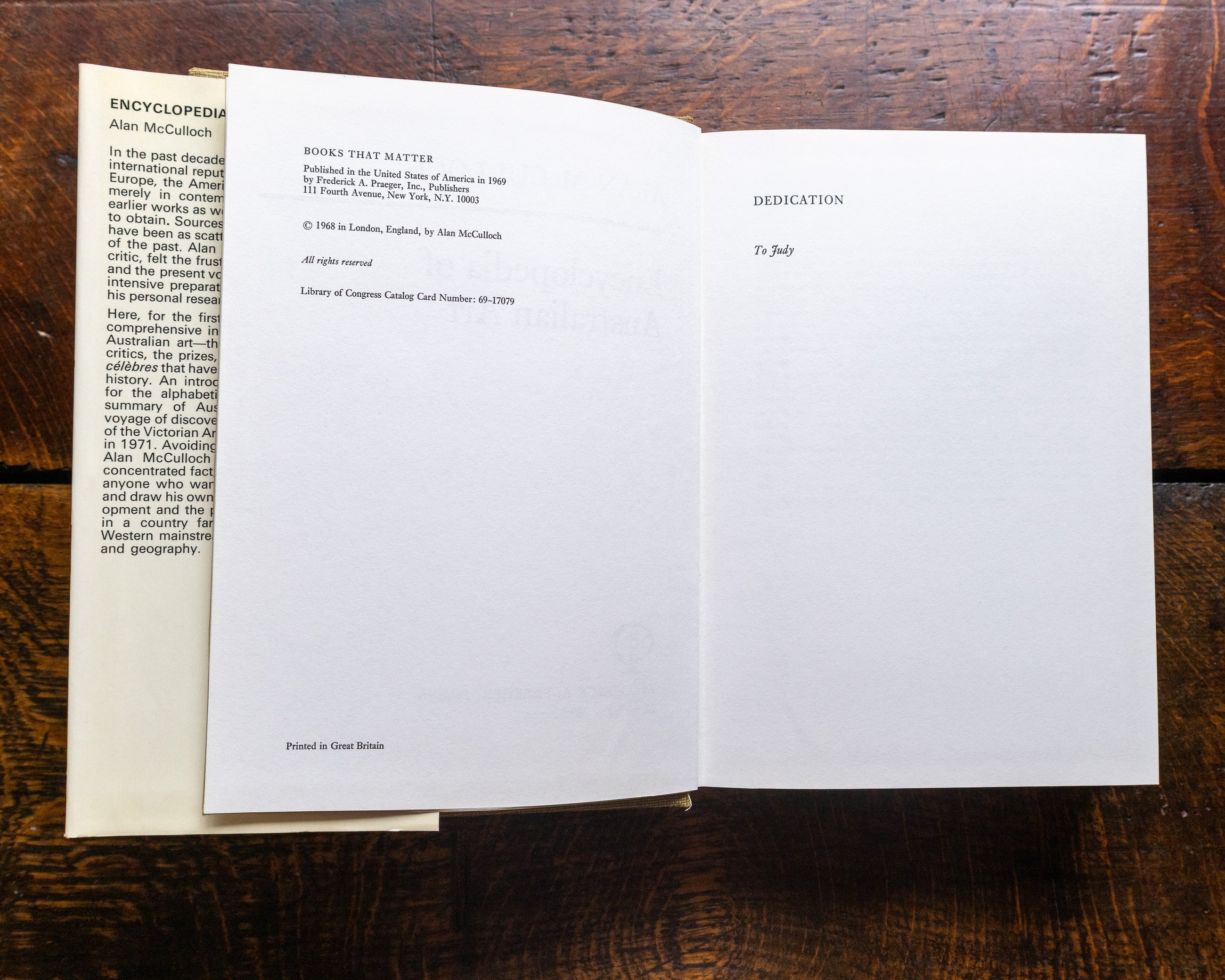 Open book on a wooden surface with text visible