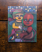 Book cover with colorful painting by Mirka Mora of two figures and a dog on a wooden surface