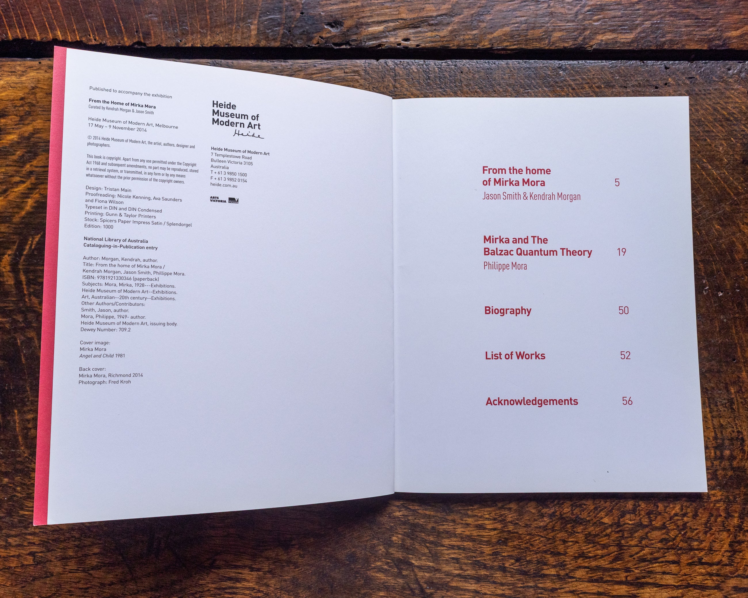 Open book with table of contents on a wooden surface