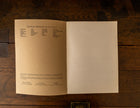 Open book on a wooden surface with text on the pages.