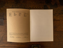Open book on a wooden surface with text on the pages.