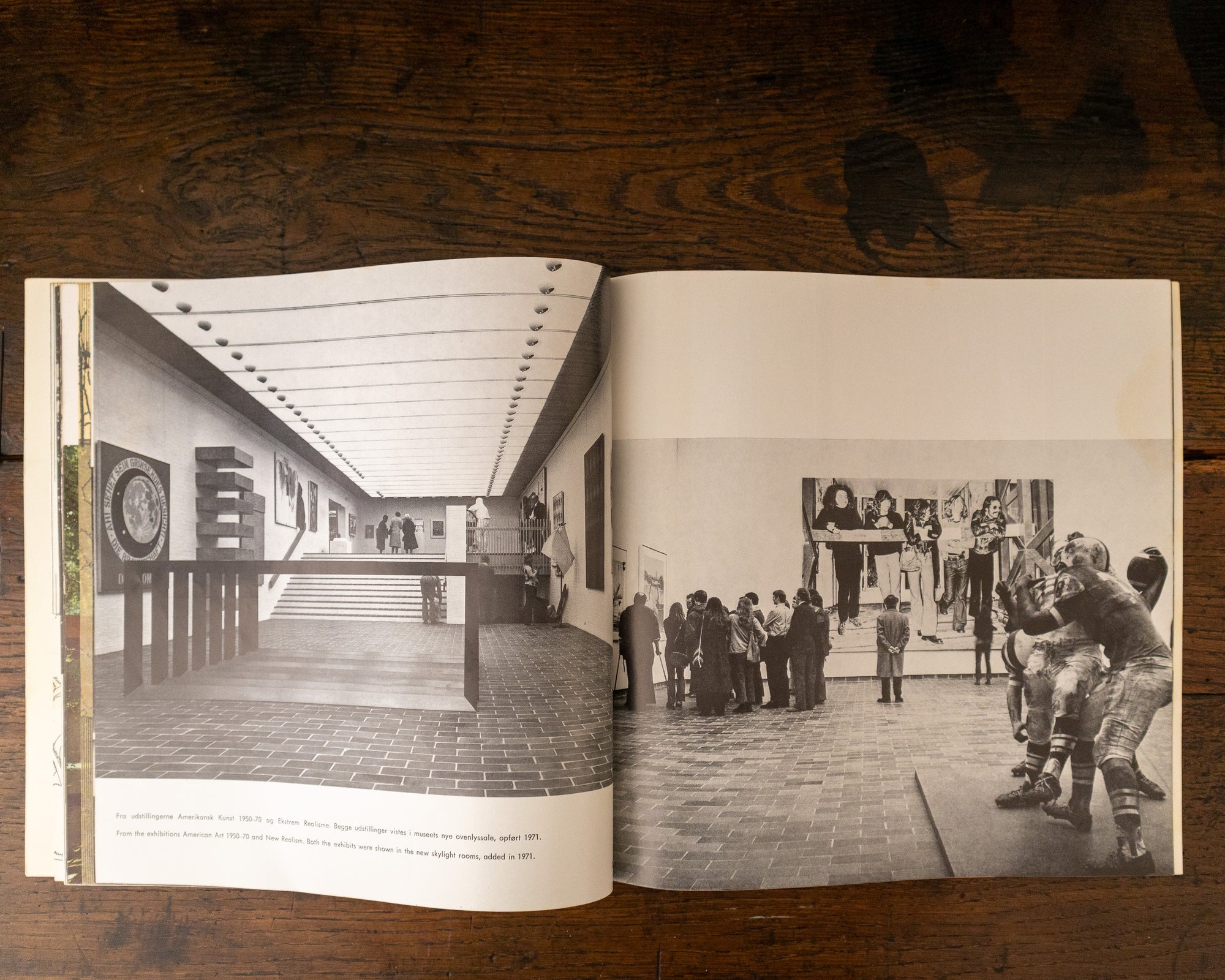 Open book showing black and white photographs of an art gallery interior.
