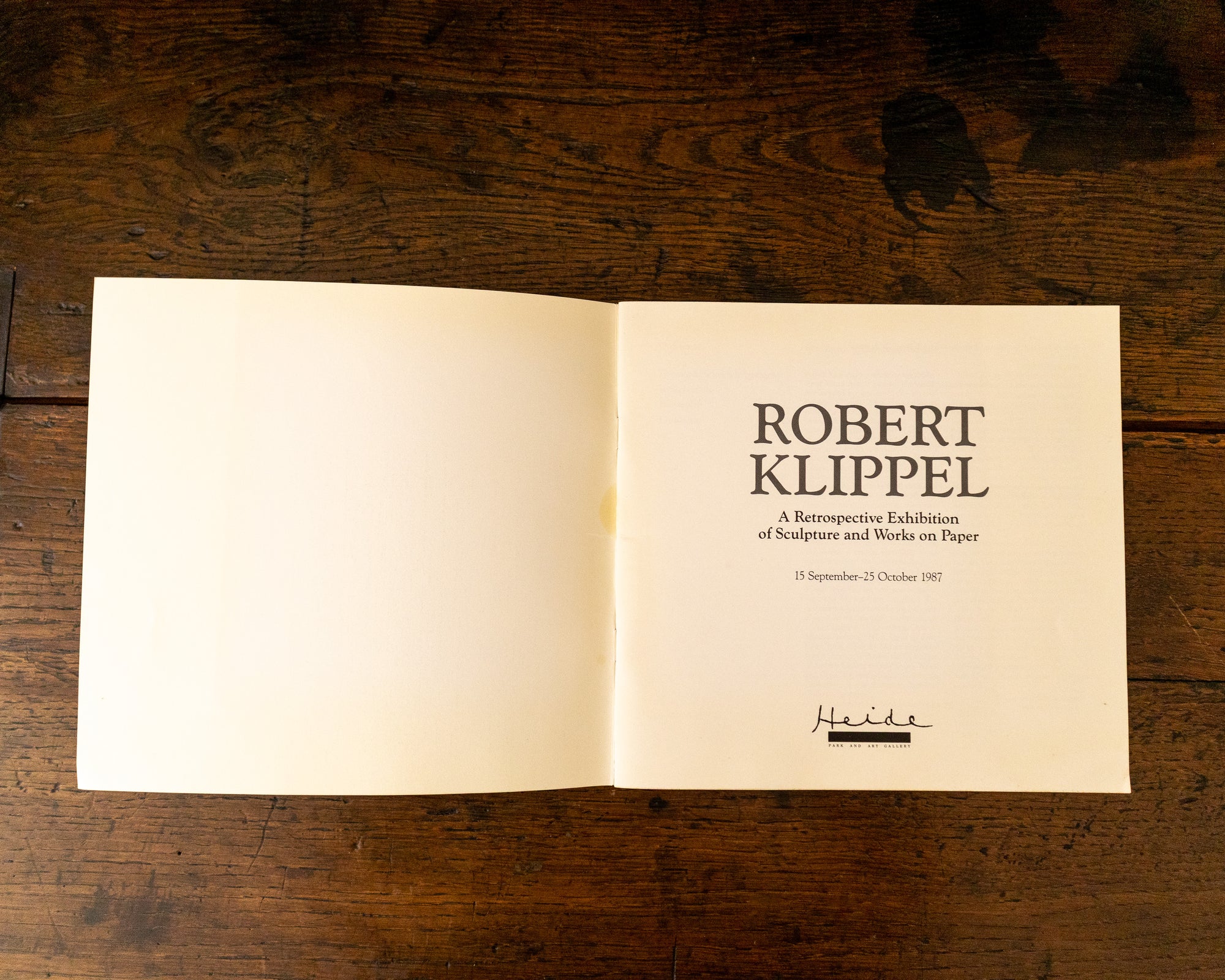 Open book with text on a wooden surface