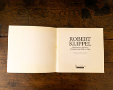 Open book with text on a wooden surface