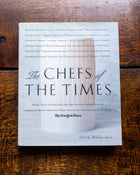 Book titled 'The Chefs of the Times' on a wooden surface