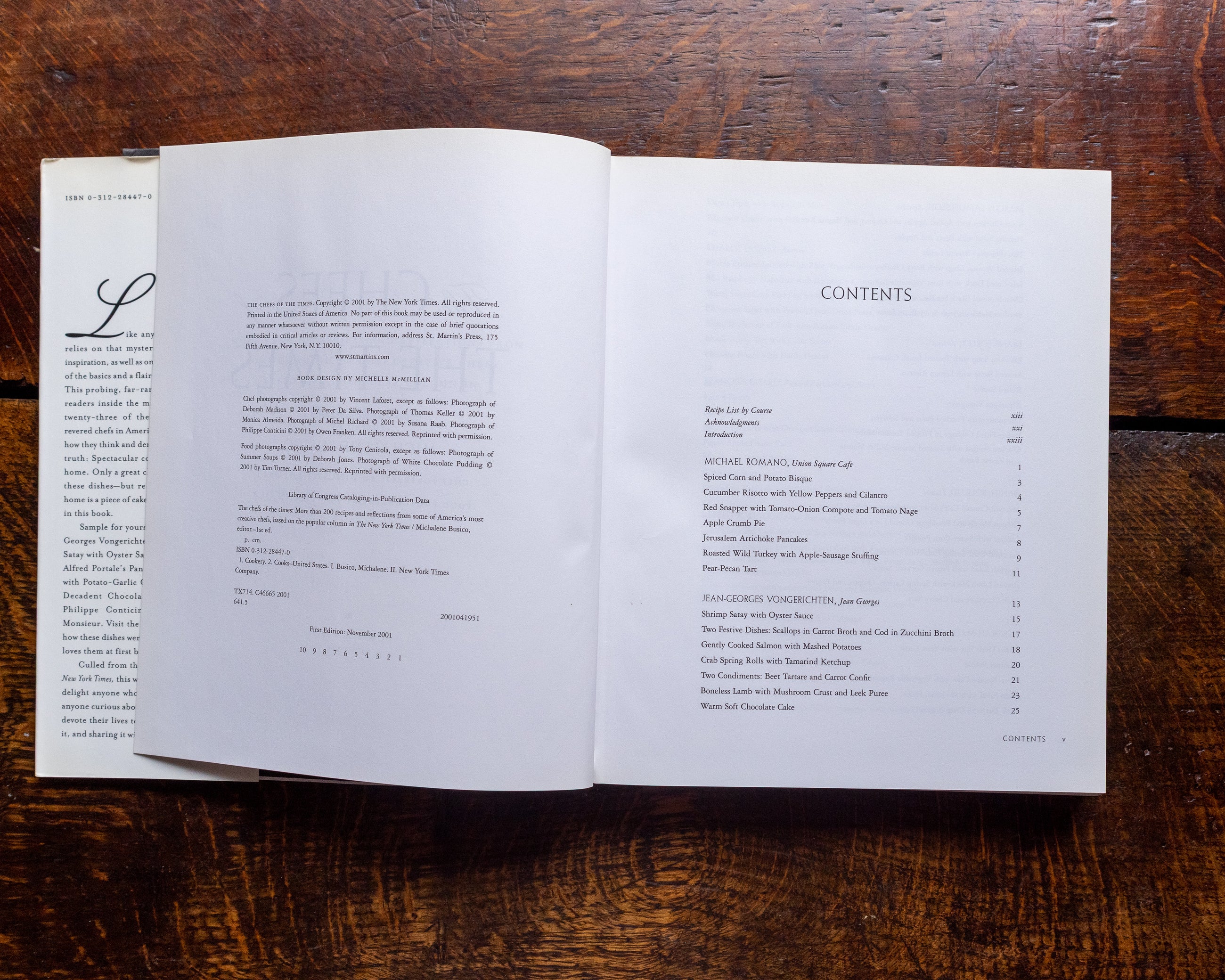 Open book with a table of contents on a wooden surface