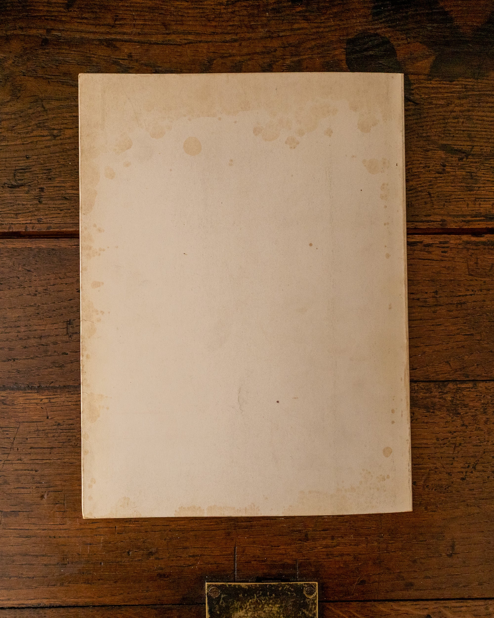 Back cover book with embossed text 'The Field' on a wooden surface