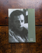 Book with a black and white portrait of Sidney Nolan on a wooden surface