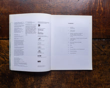 Open book with text on a wooden surface