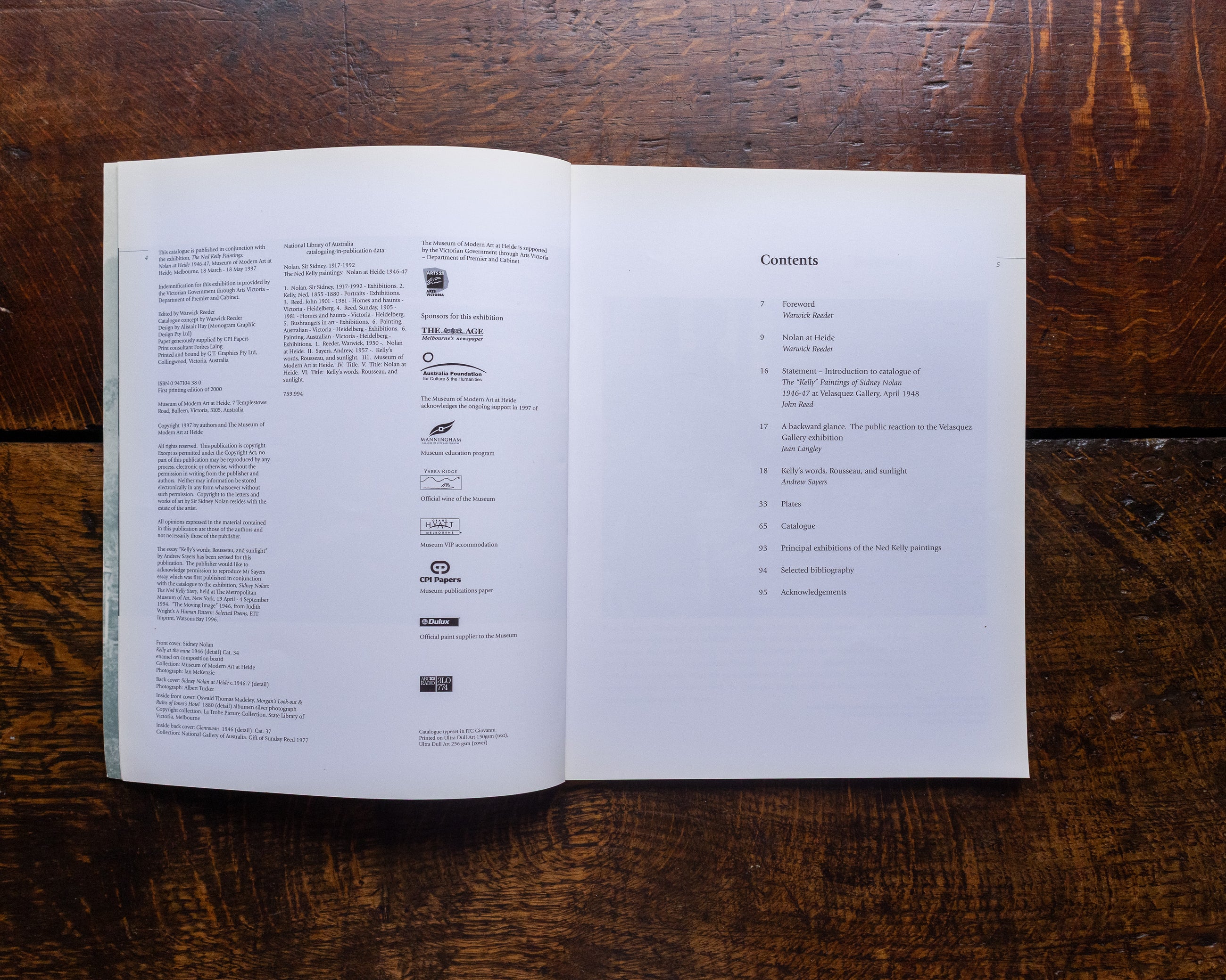 Open book with text on a wooden surface