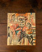 Back cover with abstract artwork on a wooden surface