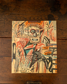 Back cover with abstract artwork on a wooden surface