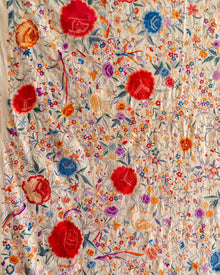 Colorful floral pattern on a embroidered fabric background