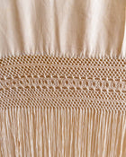 Close-up of beige fabric with intricate stitching detail