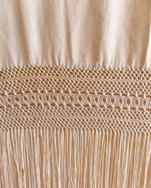 Close-up of beige fabric with intricate stitching detail