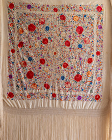 Decorative scarf with colorful floral pattern on a beige background