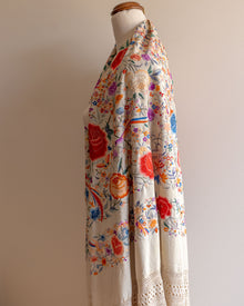 Floral patterned scarf on a mannequin against a plain background